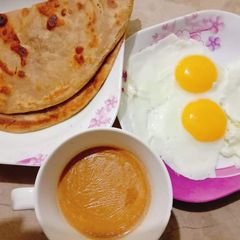 A picture of Desi Nashta (paratha,andha,chai).