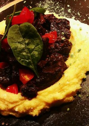 A picture of Italian Peposo on corn flour with old goat chese.