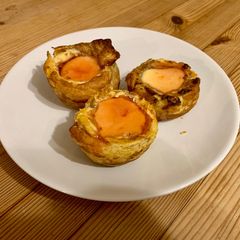 A picture of Portuguese custard tarts (natas)with blood orange caramel.