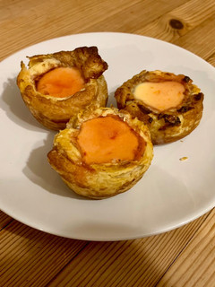 A picture of Portuguese custard tarts (natas)with blood orange caramel.