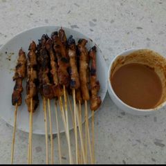 A picture of Chicken Satay (Sate Ayam) with Peanut Sauce.