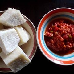 A picture of Boiled yam with fresh tomatoes sauce.