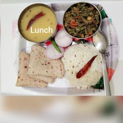A picture of Toovar dal, lobia dry bhaji, chapatis jeera rice and slice onion.