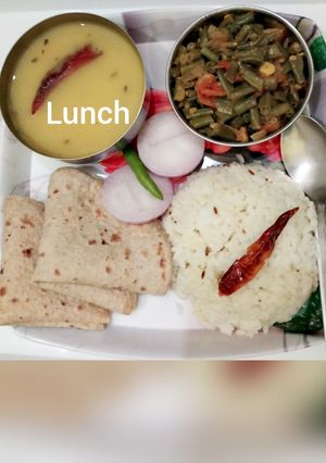 A picture of Toovar dal, lobia dry bhaji, chapatis jeera rice and slice onion.