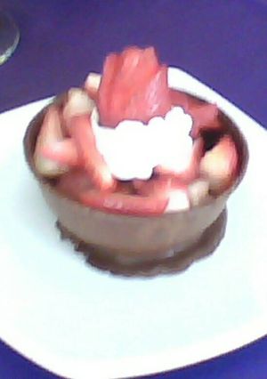 Una foto de Esfera de chocolate y frutillas con crema