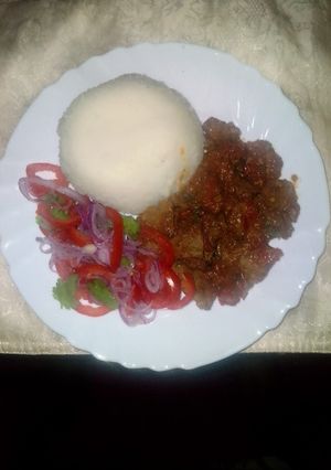 A picture of Mouth watering liver and kachumbari served with ugali.