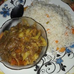 A picture of Wite rice with garbage soup.