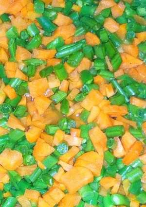 A picture of French beans with carrot veges.