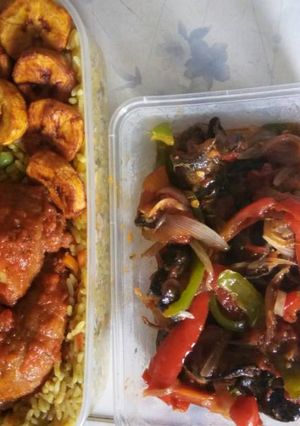 A picture of Fried rice with chicken and fried plantain.