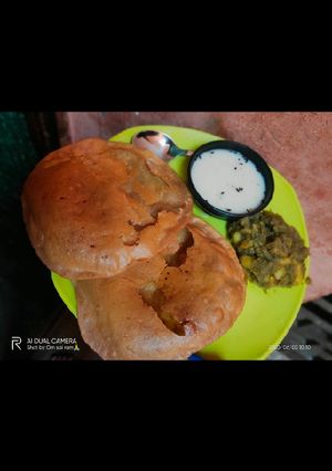 A picture of Aligarh kachori with aloo sabji and raita.