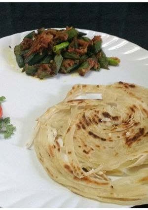 A picture of Lachha paratha with masala bhindi.