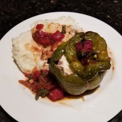 A picture of Stuffed Bell Peppers w/ Sauce.