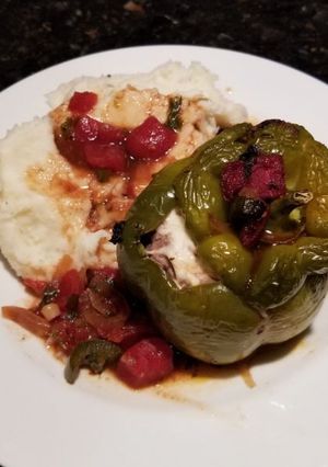 A picture of Stuffed Bell Peppers w/ Sauce.