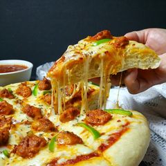 A picture of Chicken Tikka Pizza.