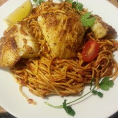 A picture of Chilean Seabass with Pasta in Marinara Sauce.