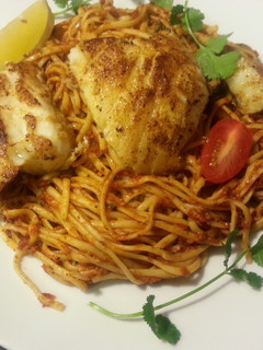 A picture of Chilean Seabass with Pasta in Marinara Sauce.