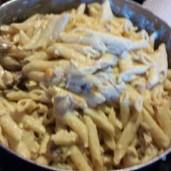 A picture of Pasta w/pork sausage, chicken and veggies.