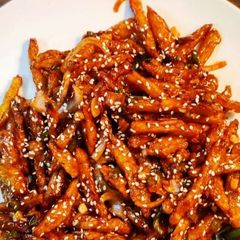 A picture of Honey fried fries with sesame.