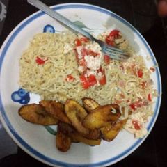 A picture of Indomine with fried plantain and scrambled egg.