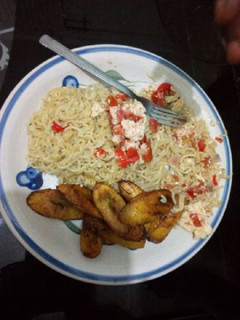 A picture of Indomine with fried plantain and scrambled egg.