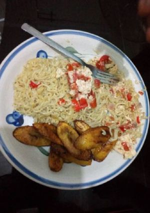 A picture of Indomine with fried plantain and scrambled egg.