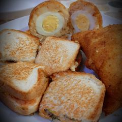 A picture of Shami Sandwich with potato egg balls.
