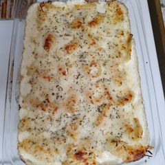 A picture of Shrimp and ricotta stuffed shells with homemade alfredo sauce.