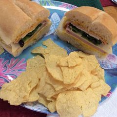 Ham, American cheese, lettuce, slices olives and mustard on Portuguese Bread 😋 A picture of Ham, American cheese, lettuce, slices olives and mustard on Portuguese Bread 😋.