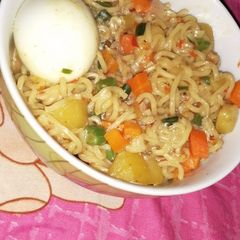 A picture of Indomie noodles with cooked egg.