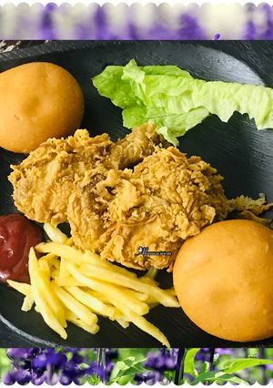 A picture of Kfc style chicken with French fries.