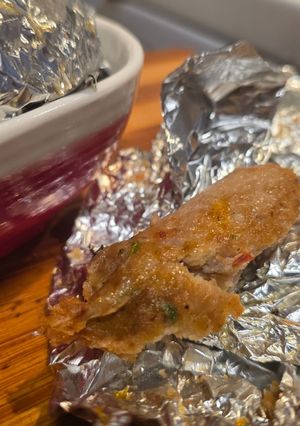 A picture of Foil-wrapped kababs.