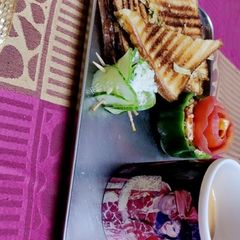 A picture of Vegetable sandwiches with cup of tea.