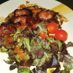 A picture of Baked egg n sweet bacon hash browns.