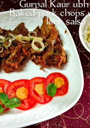 A picture of Baked pork chops with leek salsa 🐖🌿🍅🥕.