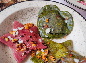 A picture of Spinach Beets Ravioli with Minced Mushroom in Bachmel Sauce.