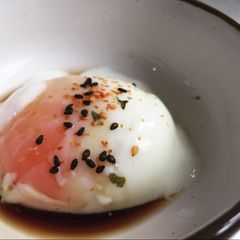 Sous vide poached egg with soy sauce and shichimi A picture of Sous vide poached egg with soy sauce and shichimi.