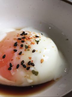 A picture of Sous vide poached egg with soy sauce and shichimi.