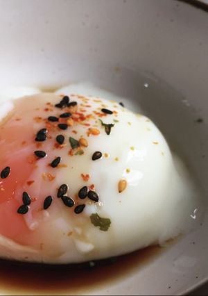 A picture of Sous vide poached egg with soy sauce and shichimi.