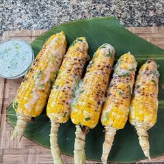 A picture of Cambodian Grilled Corn with coconut cream sauce.