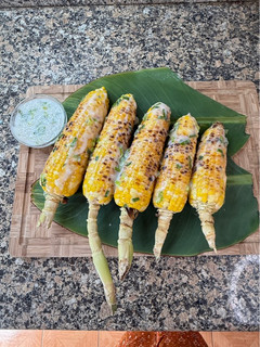 A picture of Cambodian Grilled Corn with coconut cream sauce.