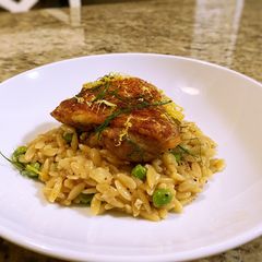 A picture of Crispy chicken thighs with lemon fennel and pea orzo.