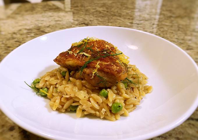 Crispy chicken thighs with lemon fennel and pea orzo