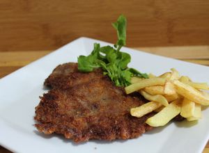 Una foto de Milanesa estilo argentino al plato
