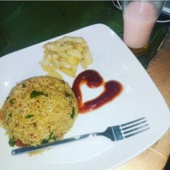 Fried rice and chips with ketchup A picture of Fried rice and chips with ketchup.