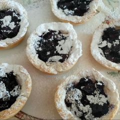 A picture of Apple and blueberry bread and butter tarts.
