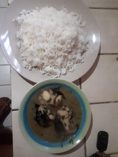 A picture of White rice with catfish and bitter leaf pepper soup.