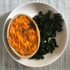 A picture of Cottage pie with vegetable mash top and black cabbage.