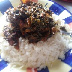 A picture of White Rice with Afang Soup.