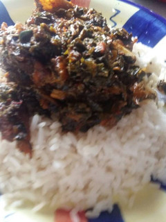 A picture of White Rice with Afang Soup.