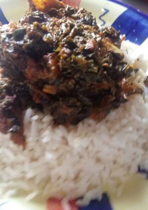 A picture of White Rice with Afang Soup.